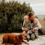 Family Beach Session Styling: A joyful family poses on the sandy shore, capturing the essence of relaxed elegance against the backdrop of sun-kissed waves and azure skies.