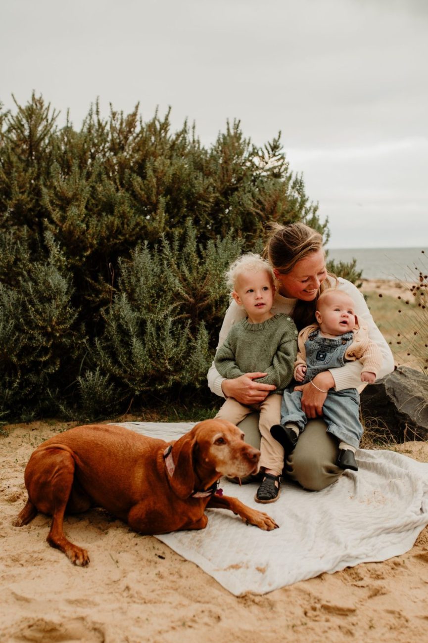 Family Beach Session Styling: A joyful family poses on the sandy shore, capturing the essence of relaxed elegance against the backdrop of sun-kissed waves and azure skies.
